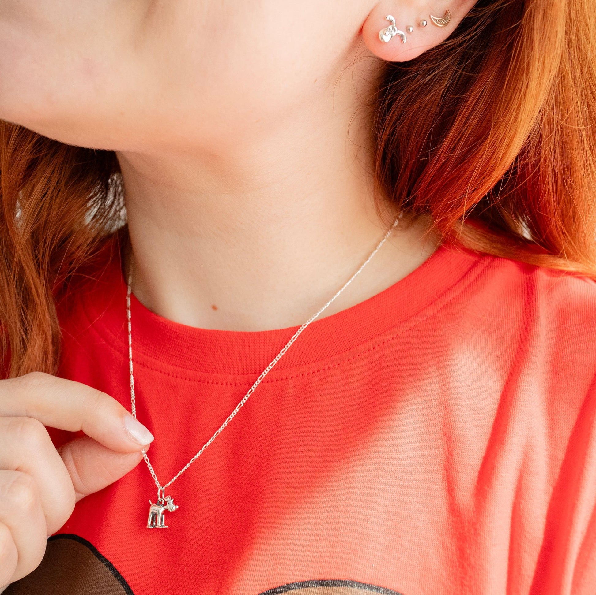 Model wearing the Standing Gromit necklace in sterling silver, a handmade Wallace and Gromit jewellery gift.