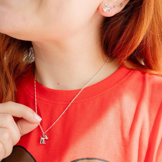Model wearing the Standing Gromit necklace in sterling silver, a handmade Wallace and Gromit jewellery gift.