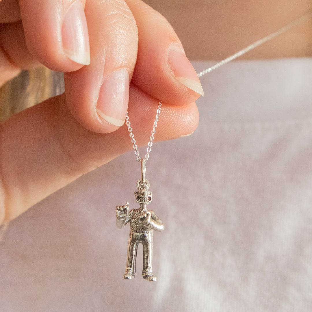 Model wearing the Standing Wallace Necklace in sterling silver, a Wallace & Gromit jewellery gift for fans