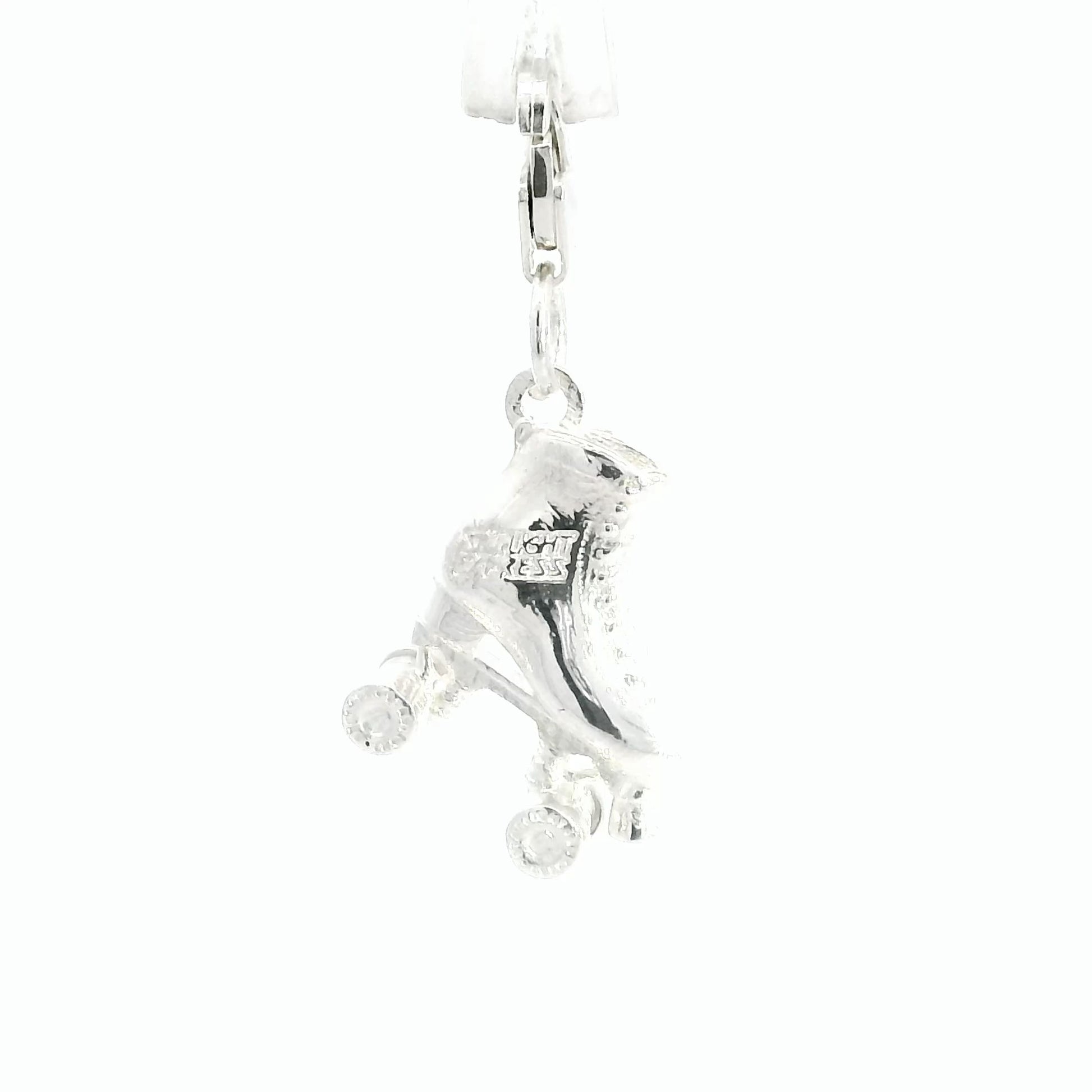 Official Starlight Express roller skate charm in recycled sterling silver with four wheels and clip-on clasp