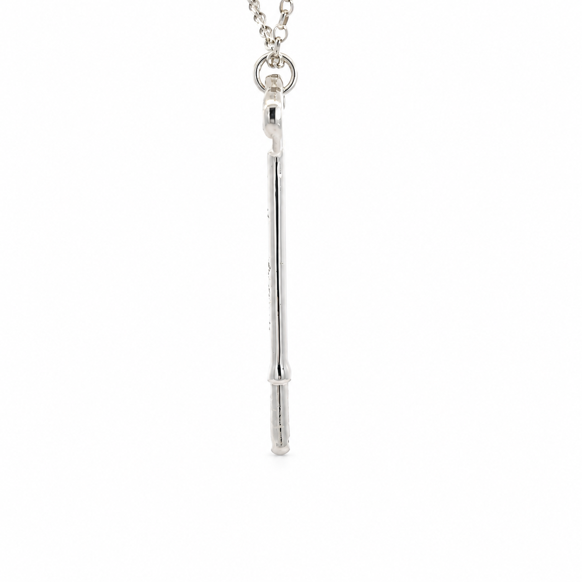 Detail view of the Phantom of the Opera solid sterling silver key pendant showing its handmade finish