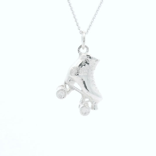 Close-up of a sterling silver roller skate charm necklace inspired by Andrew Lloyd Webber’s Starlight Express.