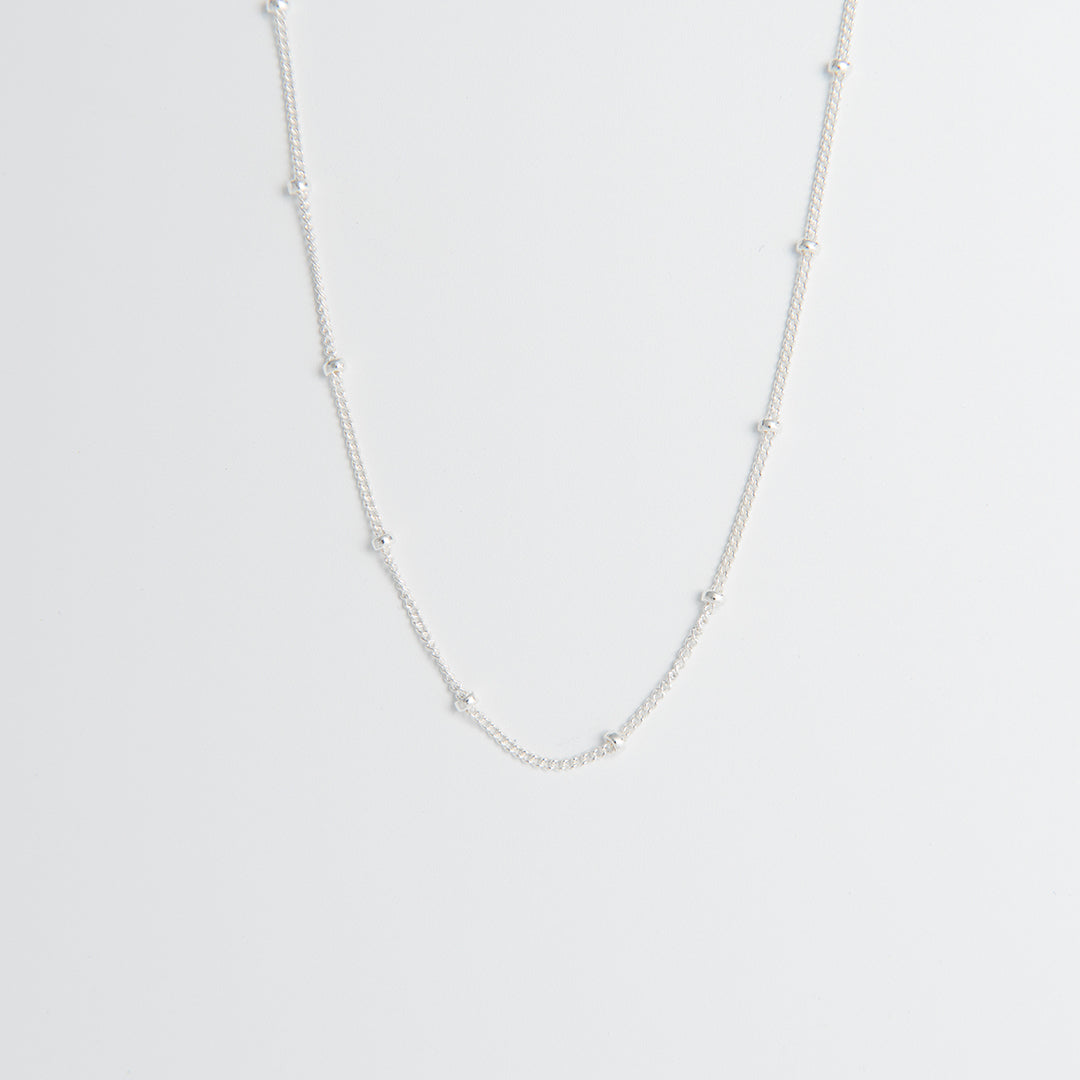 Sterling silver satellite chain necklace featuring polished silver beads. A versatile, dainty chain available in 40cm or 45cm, perfect for layering or wearing solo.