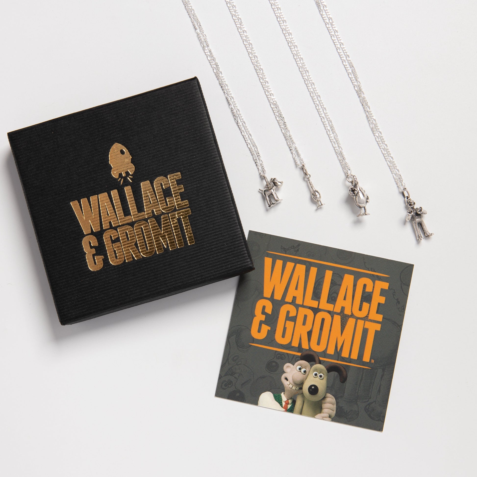 Standing Gromit necklace presented with Wallace and Gromit Licensed To Charm packaging.