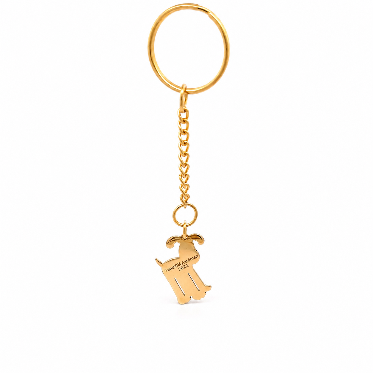 Back view of gold Wallace & Gromit Gromit bag charm keyring showing engraved Aardman detail on a white background.