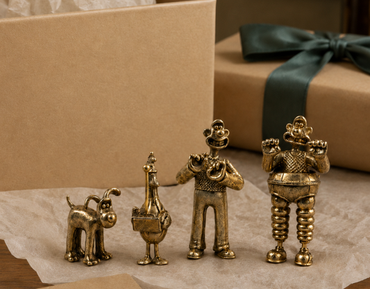 Wallace & Gromit bronze collectables styled with a wrapped gift for a nostalgic present