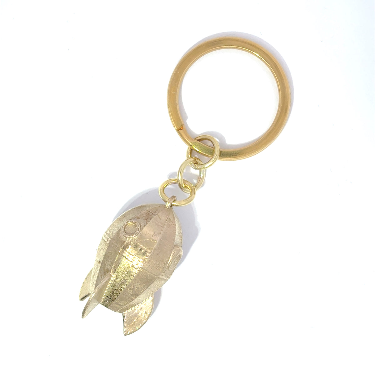 Close-up of Wallace & Gromit brass rocket keyring detailing