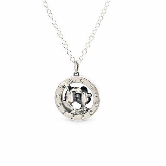 Full view of the sterling silver Wallace & Gromit porthole necklace showing the round pendant suspended from its silver chain.