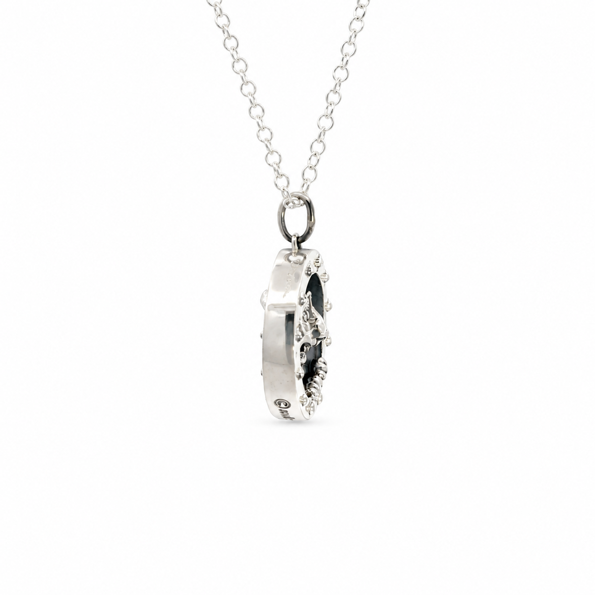 Side profile of the Wallace & Gromit sterling silver porthole pendant showing its three-dimensional design and depth