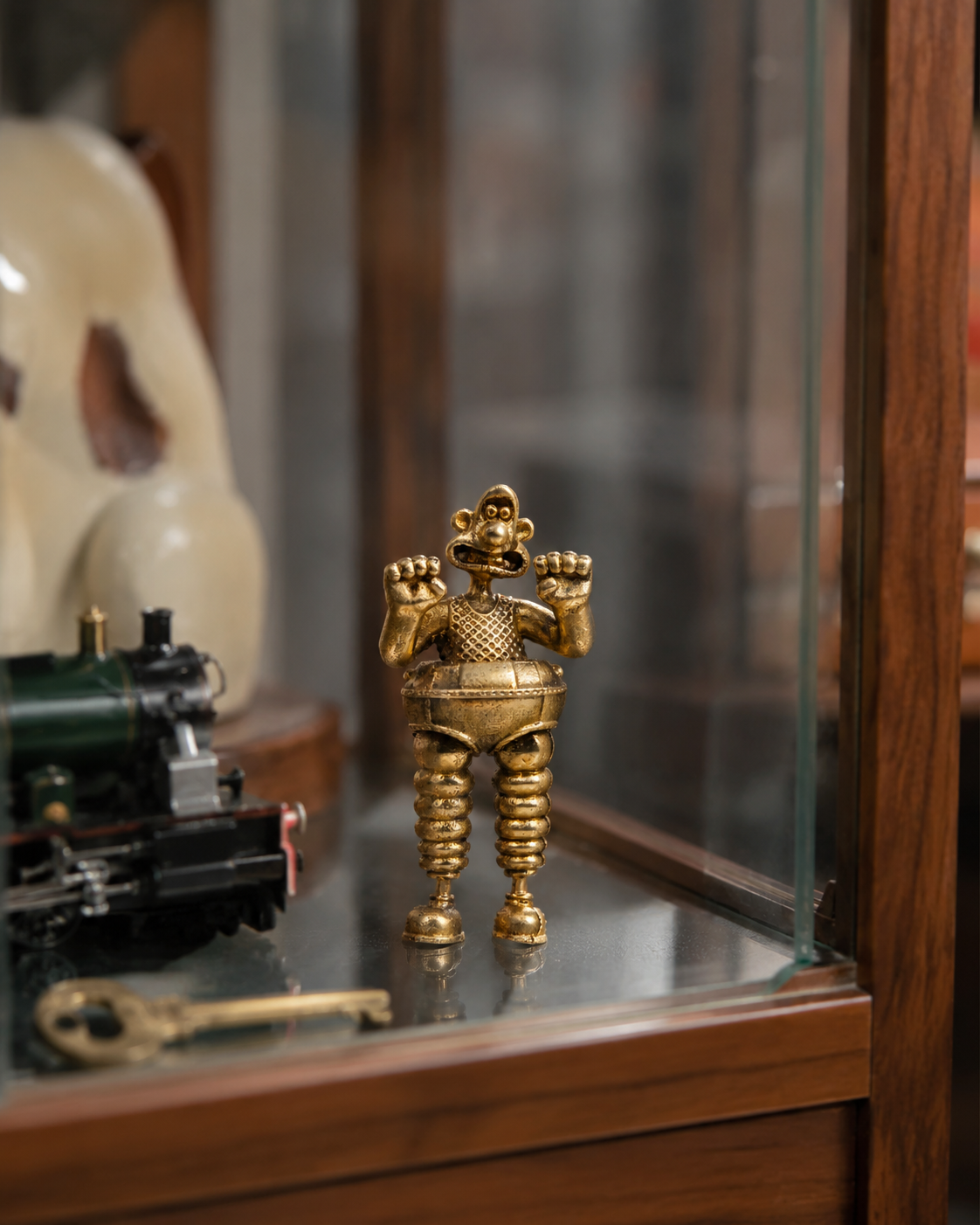 Wallace in the Wrong Trousers miniature bronze figurine displayed on a collection shelf with other small collectables